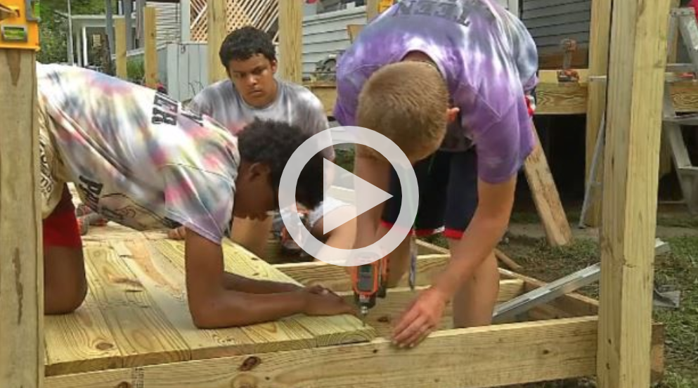 Teens helping build a wheelchair ramp