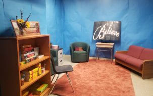 Blue room with a sign that says Believe