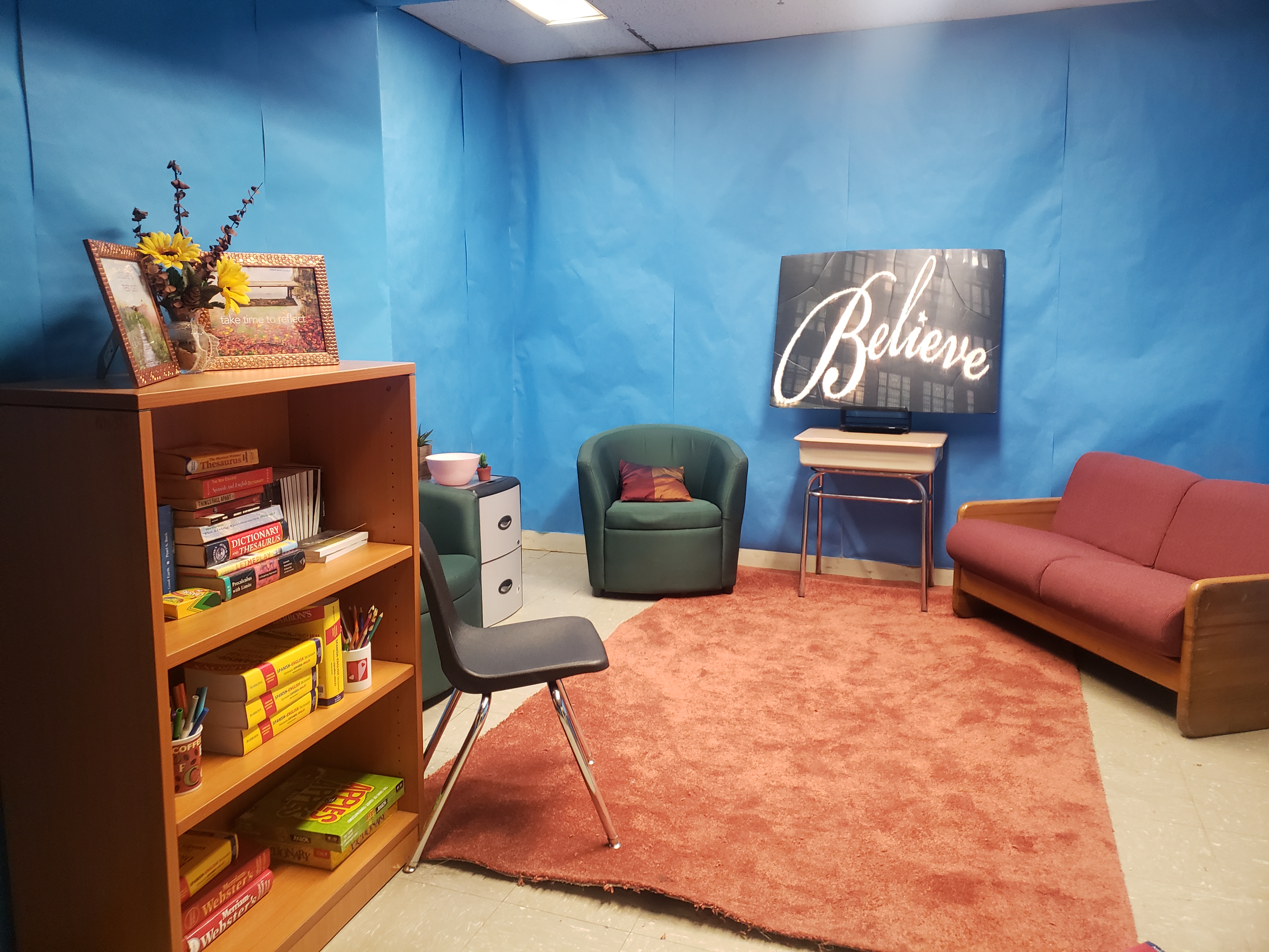 Blue room with a sign that says Believe